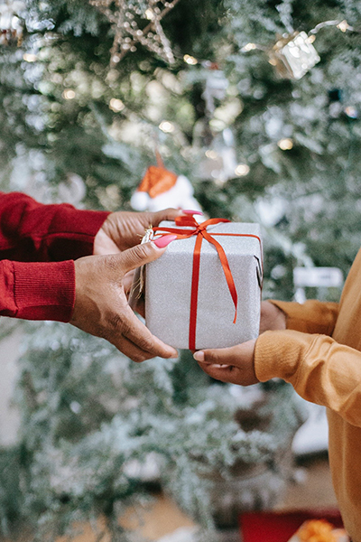 woman giving gift to kid